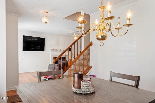 4108 Lazyriver Ln, Durham, NC 27712 - dining area featuring ceiling fan, stairway, crown molding, wood finished floors, and a chandelier