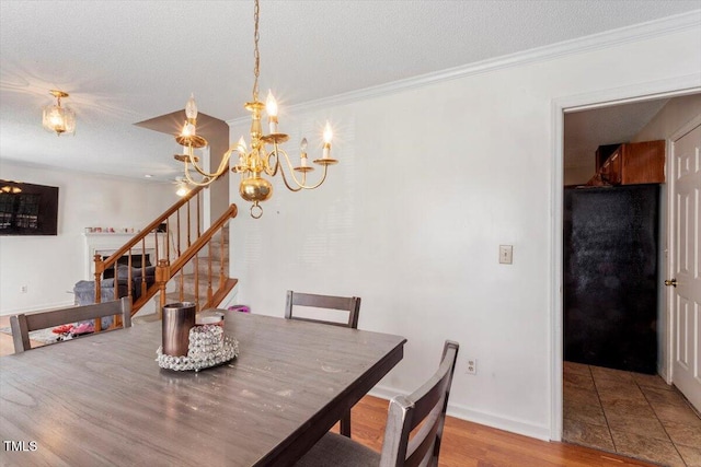 4108 Lazyriver Ln, Durham, NC 27712 - dining area featuring a chandelier, stairs, light wood-type flooring, crown molding, and baseboards