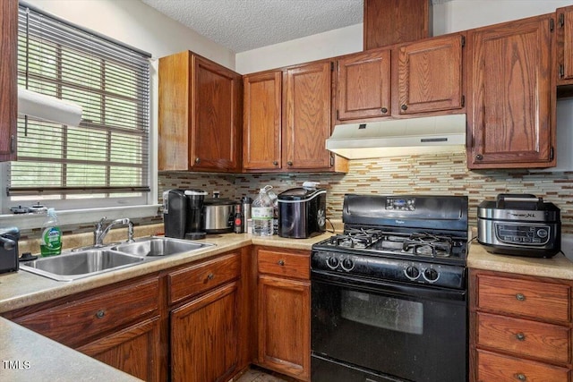 4108 Lazyriver Ln, Durham, NC 27712 - kitchen featuring under cabinet range hood, black range with gas cooktop, a sink, light countertops, and a textured ceiling