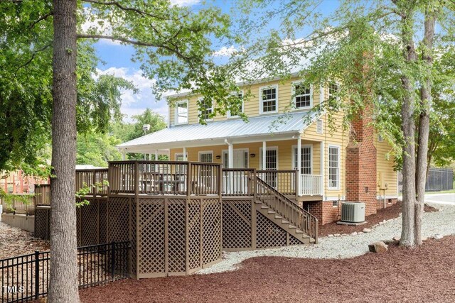 4108 Lazyriver Ln, Durham, NC 27712 - rear view of property featuring stairway, cooling unit, covered porch, and metal roof