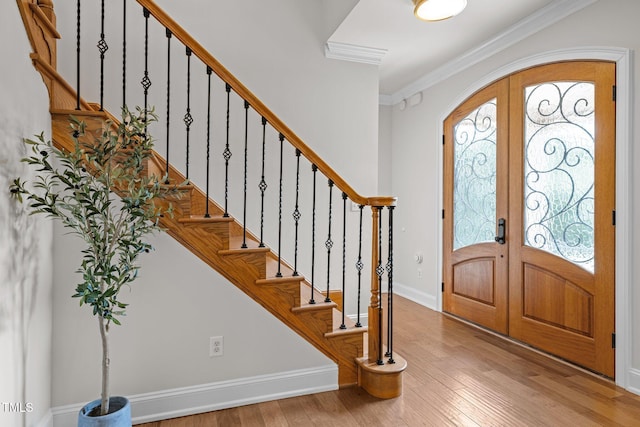 4913 Great Meadows Ct, Raleigh, NC 27609 - entrance foyer featuring french doors, arched walkways, light wood-style flooring, healthy amount of natural light, and ornamental molding