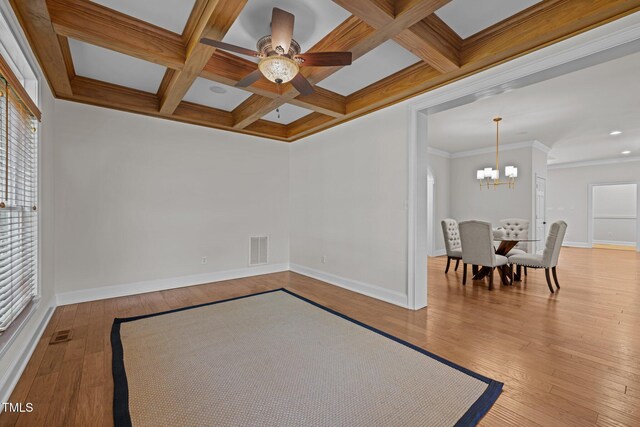 4913 Great Meadows Ct, Raleigh, NC 27609 - spare room with a chandelier, hardwood / wood-style flooring, baseboards, healthy amount of natural light, and beamed ceiling