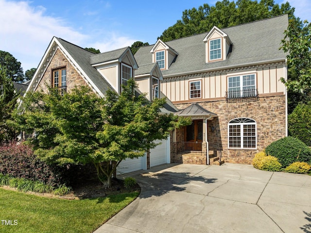 4913 Great Meadows Ct, Raleigh, NC 27609 - view of front of home with driveway, stone siding, board and batten siding, and a garage