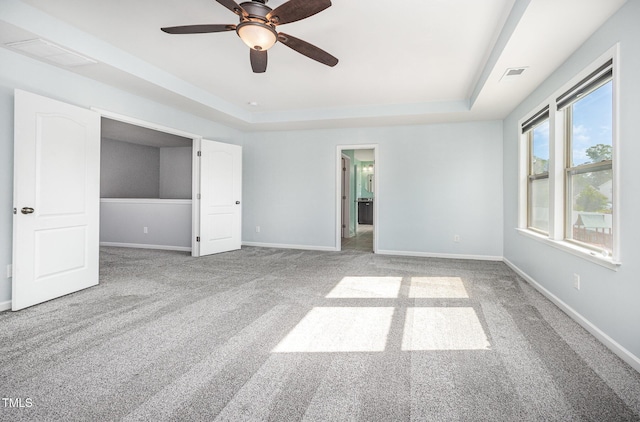 1305 Ivey Grove Ct, Fuquay Varina, NC 27526 - unfurnished bedroom with carpet flooring, a raised ceiling, and a ceiling fan