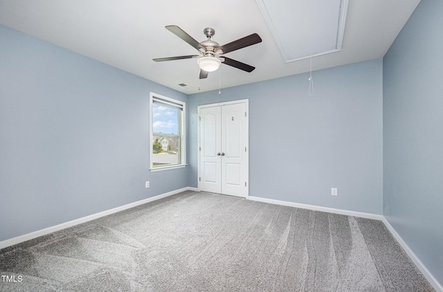 1305 Ivey Grove Ct, Fuquay Varina, NC 27526 - unfurnished bedroom with attic access, carpet flooring, a closet, and a ceiling fan
