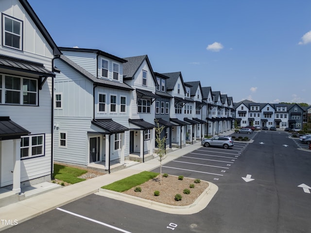 4821 Gossamer Ln Unit 102, Raleigh, NC 27616 - uncovered parking lot featuring a residential view