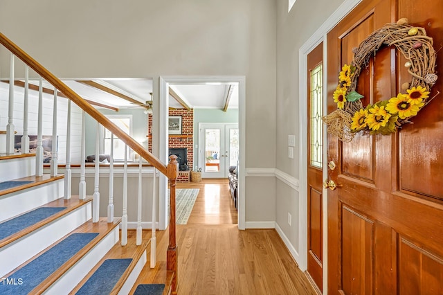 4702 Pleasant Green Rd, Durham, NC 27705 - entrance foyer featuring light wood finished floors, stairs, a brick fireplace, a ceiling fan, and baseboards