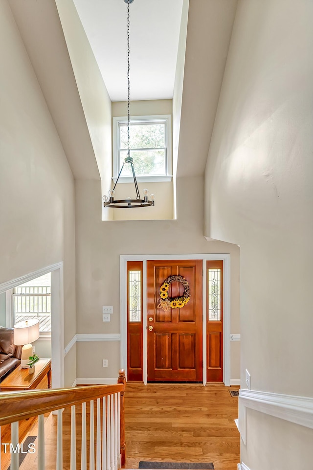 4702 Pleasant Green Rd, Durham, NC 27705 - foyer entrance featuring a towering ceiling, a chandelier, healthy amount of natural light, and light wood-style flooring
