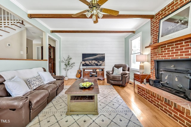 4702 Pleasant Green Rd, Durham, NC 27705 - living area featuring light wood-type flooring, a ceiling fan, ornamental molding, beamed ceiling, and a fireplace