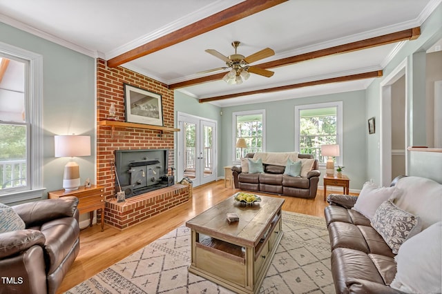 4702 Pleasant Green Rd, Durham, NC 27705 - living room featuring light wood finished floors, a ceiling fan, a brick fireplace, beamed ceiling, and ornamental molding
