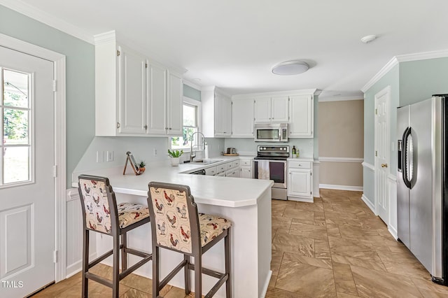 4702 Pleasant Green Rd, Durham, NC 27705 - kitchen with stainless steel appliances, a sink, a peninsula, light countertops, and white cabinetry