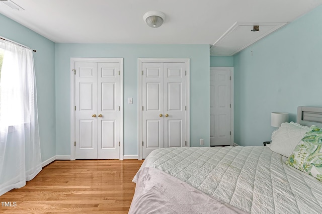 4702 Pleasant Green Rd, Durham, NC 27705 - bedroom featuring attic access, two closets, light wood-type flooring, and baseboards