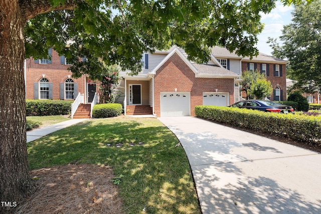 5644 Picnic Rock Ln, Raleigh, NC 27613 - view of front facade with brick siding, concrete driveway, a front yard, and an attached garage