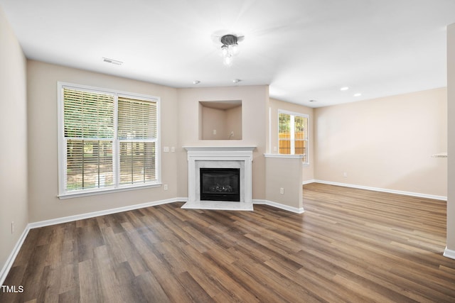 5644 Picnic Rock Ln, Raleigh, NC 27613 - unfurnished living room with wood finished floors, a fireplace, and recessed lighting