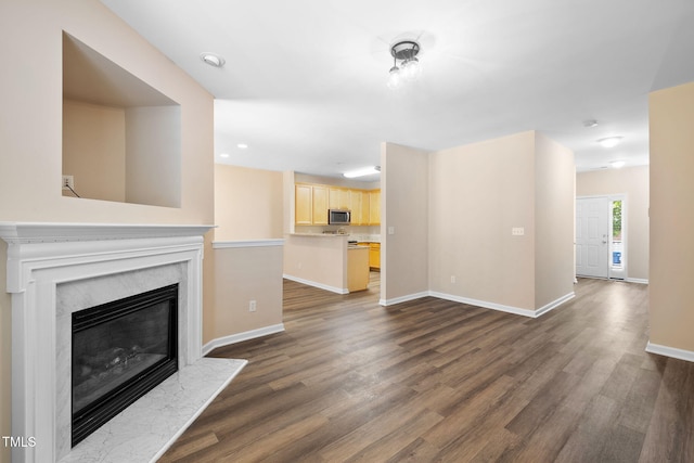 5644 Picnic Rock Ln, Raleigh, NC 27613 - unfurnished living room with dark wood-style floors and a premium fireplace