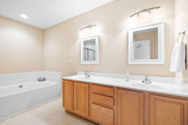 5644 Picnic Rock Ln, Raleigh, NC 27613 - bathroom featuring double vanity and a garden tub
