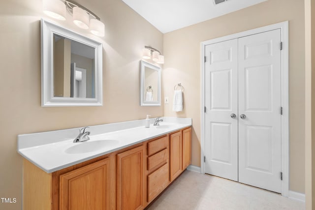 5644 Picnic Rock Ln, Raleigh, NC 27613 - bathroom featuring double vanity and baseboards
