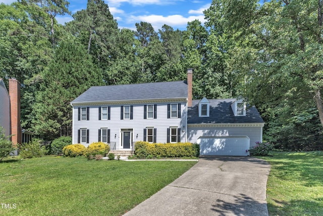 6201 Bayswater Trl, Raleigh, NC 27612 - colonial home featuring concrete driveway, a front yard, an attached garage, and a chimney