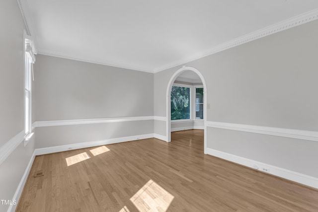 6201 Bayswater Trl, Raleigh, NC 27612 - empty room with wood finished floors, baseboards, ornamental molding, and arched walkways