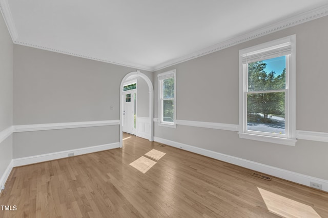 6201 Bayswater Trl, Raleigh, NC 27612 - spare room featuring crown molding, wood finished floors, arched walkways, and baseboards