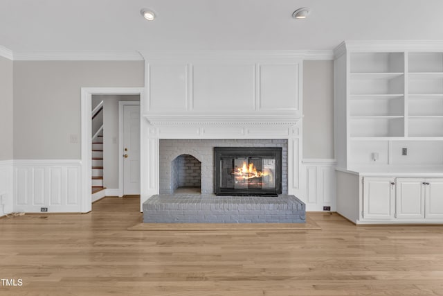 6201 Bayswater Trl, Raleigh, NC 27612 - detailed view of wood finished floors, a fireplace, ornamental molding, recessed lighting, and wainscoting