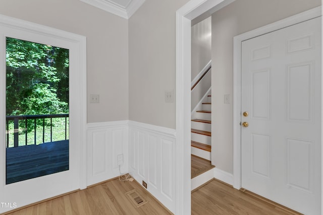 6201 Bayswater Trl, Raleigh, NC 27612 - foyer entrance with ornamental molding, light wood finished floors, and stairway