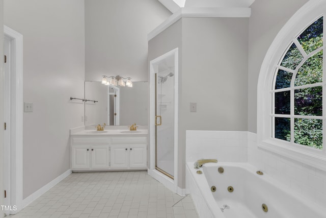 6201 Bayswater Trl, Raleigh, NC 27612 - bathroom featuring a stall shower, double vanity, a jetted tub, and plenty of natural light