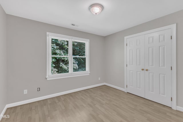 6201 Bayswater Trl, Raleigh, NC 27612 - unfurnished bedroom featuring light wood-type flooring, baseboards, and a closet