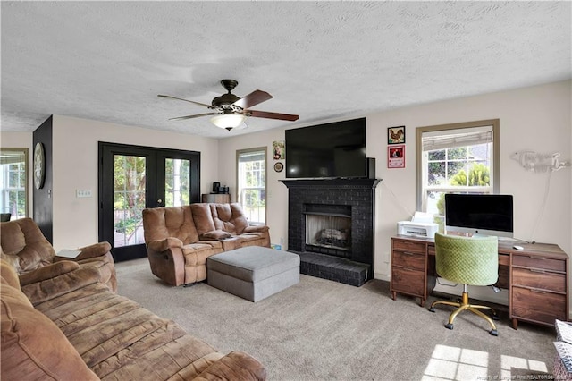 717 Stone Cross Dr, Spring Lake, NC 28390 - carpeted living area with plenty of natural light, a fireplace, a textured ceiling, and ceiling fan