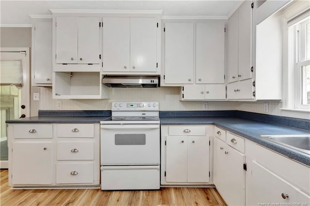 1519 Magnolia Dr, Fairmont, NC 28340 - kitchen featuring white range with electric stovetop, under cabinet range hood, light wood-style flooring, dark countertops, and ornamental molding