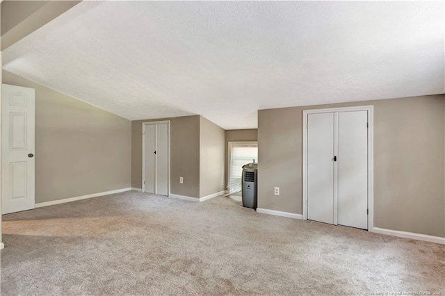 1519 Magnolia Dr, Fairmont, NC 28340 - additional living space with a textured ceiling, carpet floors, baseboards, and vaulted ceiling