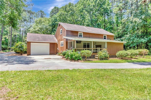 1519 Magnolia Dr, Fairmont, NC 28340 - view of front of home with driveway, covered porch, a garage, roof with shingles, and a front yard