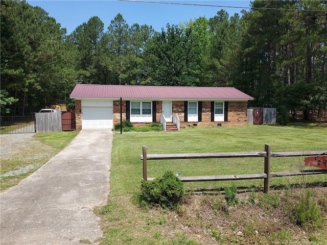 844 Montrose Rd, Raeford, NC 28376 - ranch-style home with brick siding, concrete driveway, an attached garage, and metal roof