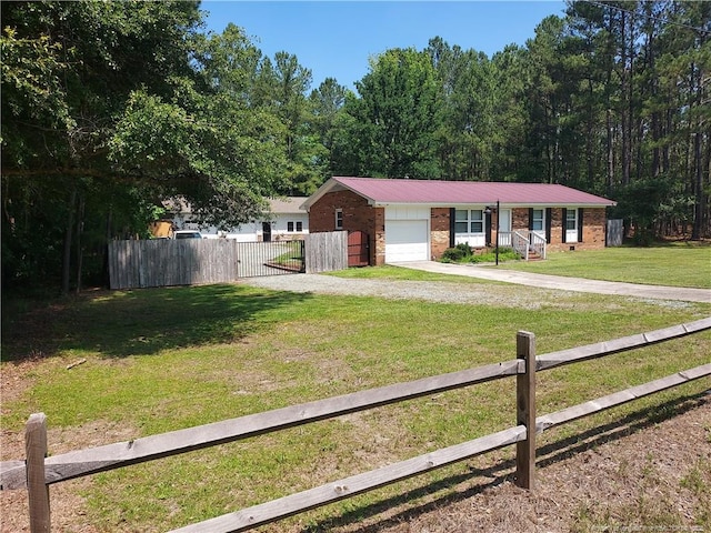 844 Montrose Rd, Raeford, NC 28376 - ranch-style home featuring driveway, an attached garage, a gate, brick siding, and metal roof
