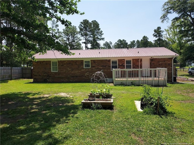 844 Montrose Rd, Raeford, NC 28376 - back of house featuring a wooden deck, brick siding, and metal roof