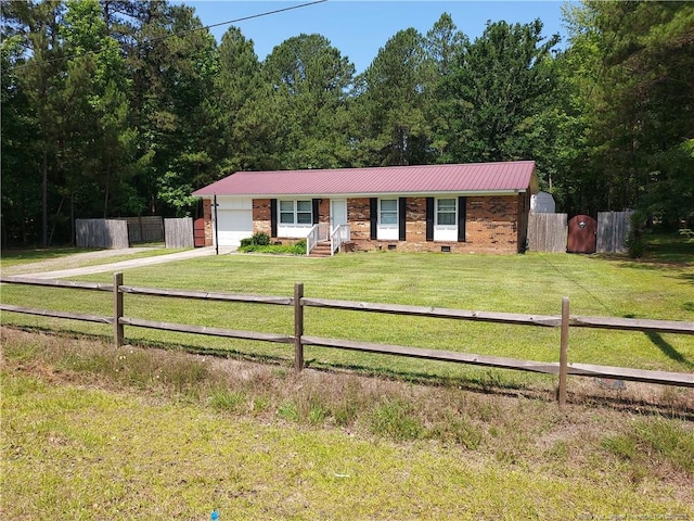 844 Montrose Rd, Raeford, NC 28376 - single story home with a garage, concrete driveway, metal roof, and brick siding