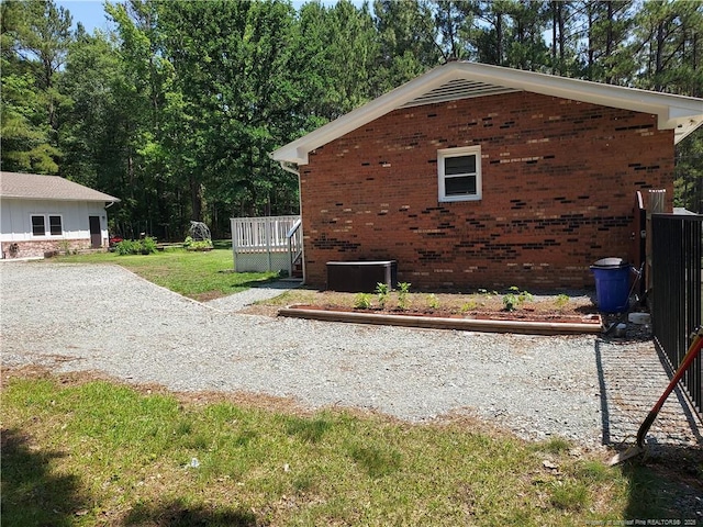 844 Montrose Rd, Raeford, NC 28376 - view of home's exterior with brick siding, a yard, and central AC