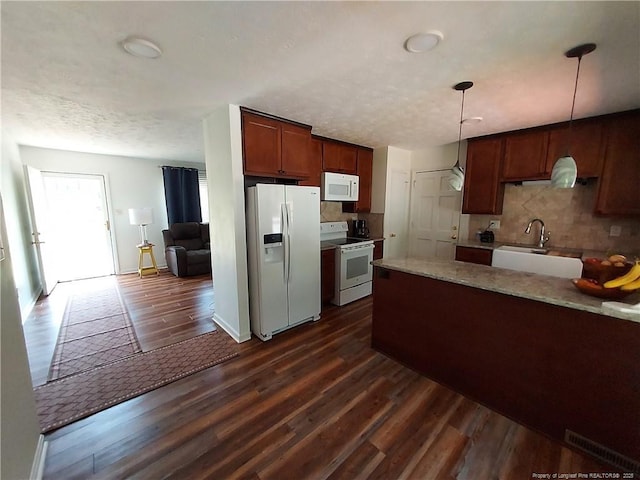 844 Montrose Rd, Raeford, NC 28376 - kitchen with white appliances, dark wood-type flooring, a sink, and tasteful backsplash