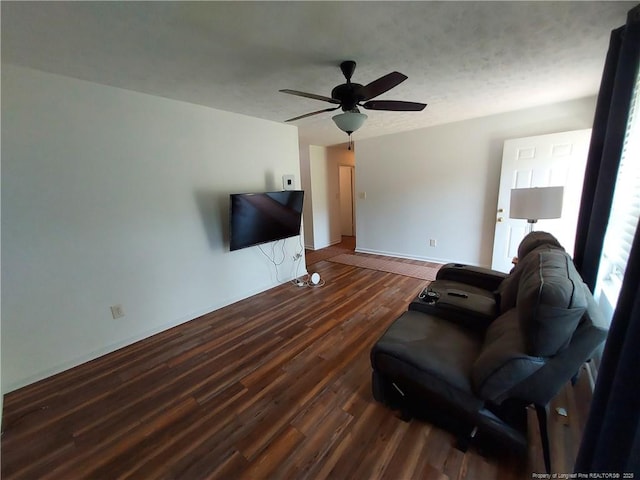 844 Montrose Rd, Raeford, NC 28376 - living room featuring dark wood-style flooring, a ceiling fan, and baseboards