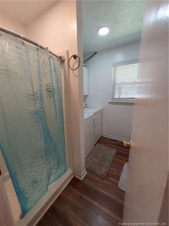 844 Montrose Rd, Raeford, NC 28376 - bathroom featuring washer and clothes dryer, wood finished floors, a stall shower, vanity, and baseboards