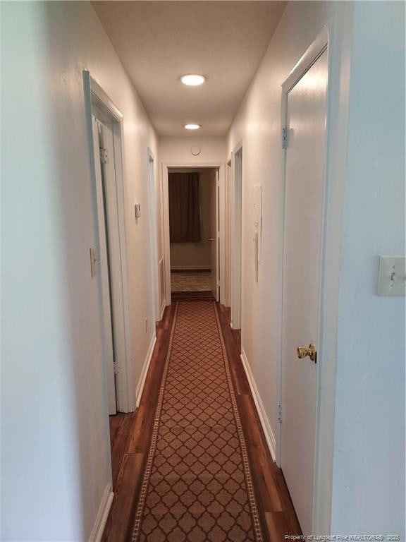 844 Montrose Rd, Raeford, NC 28376 - hall with dark wood-style flooring and baseboards