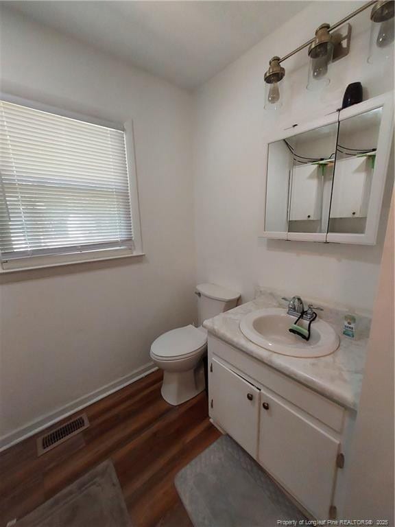 844 Montrose Rd, Raeford, NC 28376 - bathroom with vanity, toilet, and wood finished floors