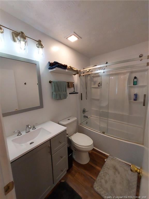 844 Montrose Rd, Raeford, NC 28376 - bathroom featuring wood finished floors, vanity, toilet, and enclosed tub / shower combo