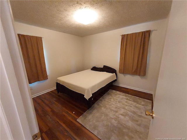 844 Montrose Rd, Raeford, NC 28376 - bedroom featuring a textured ceiling, wood finished floors, and baseboards