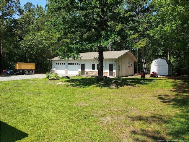 844 Montrose Rd, Raeford, NC 28376 - view of front facade with board and batten siding, gravel driveway, a garage, and a front lawn