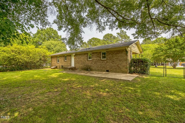 605 Sexton Ave, Zebulon, NC 27597 - rear view of property featuring a patio area, a gate, brick siding, and crawl space
