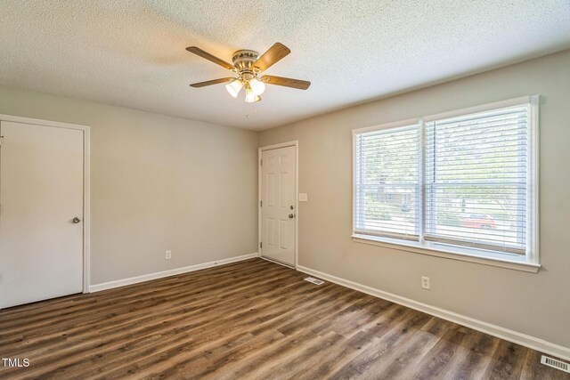 605 Sexton Ave, Zebulon, NC 27597 - empty room with wood finished floors, ceiling fan, baseboards, and a textured ceiling