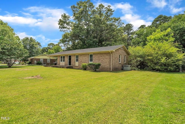 605 Sexton Ave, Zebulon, NC 27597 - view of front facade with brick siding, a front yard, and central AC