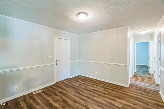605 Sexton Ave, Zebulon, NC 27597 - spare room with attic access, dark wood-type flooring, crown molding, a textured ceiling, and baseboards