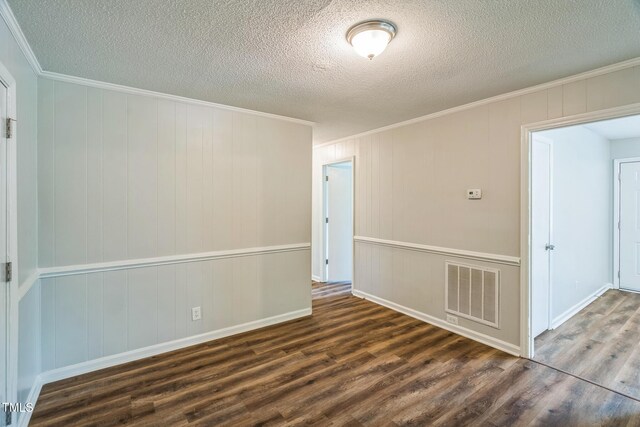 605 Sexton Ave, Zebulon, NC 27597 - empty room featuring wood finished floors, crown molding, a textured ceiling, and baseboards